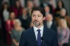Prime Minister Justin Trudeau stands in front of his cabinet as he speaks to media during the final day of the Liberal cabinet retreat at the Fairmont Hotel in Winnipeg, Tuesday, Jan. 21, 2020. THE CANADIAN PRESS/Mike Sudoma