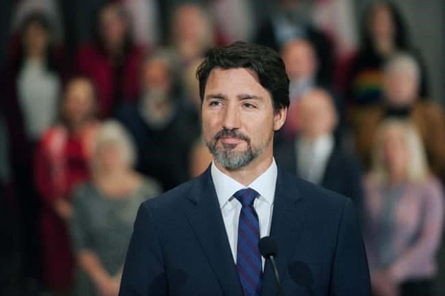 Prime Minister Justin Trudeau stands in front of his cabinet as he speaks to media during the final day of the Liberal cabinet retreat at the Fairmont Hotel in Winnipeg, Tuesday, Jan. 21, 2020. THE CANADIAN PRESS/Mike Sudoma