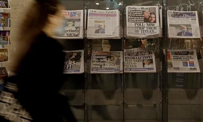 FILE - In this file photo dated Wednesday, March 10, 2021, a pedestrian passes newspapers on display with front pages featuring images of members of the royal family, outside a shop in London. In a TV interview with Oprah Winfrey, Prince Harry and Meghan were critical of the British media, and while some say their criticism is unfair, some hope the interview will trigger changes. (AP Photo/Kirsty Wigglesworth, FILE)