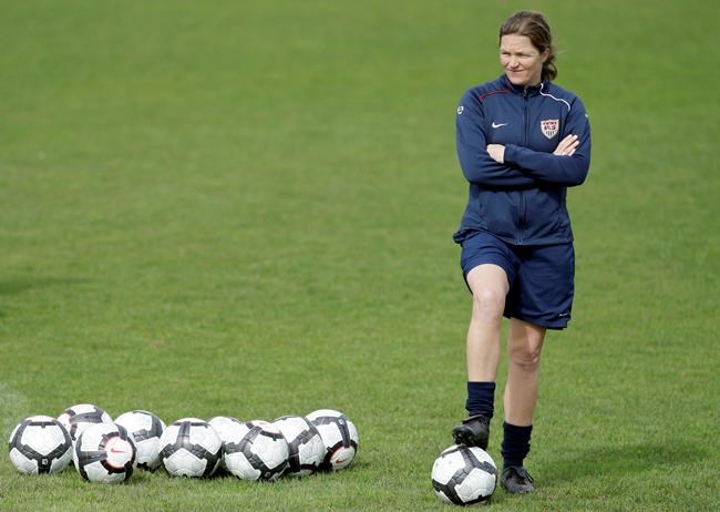 FILE - In this file photo dated Sunday, Feb. 28 2010, Hege Riise, from Norway, assistant coach of the United States Women's Soccer team, watches the players during a training session, in Guia, southern Portugal. Hege Riise will temporarily take over as coach of the England women’s national soccer team following Phil Neville’s departure. (AP Photo/Armando Franca, FILE)