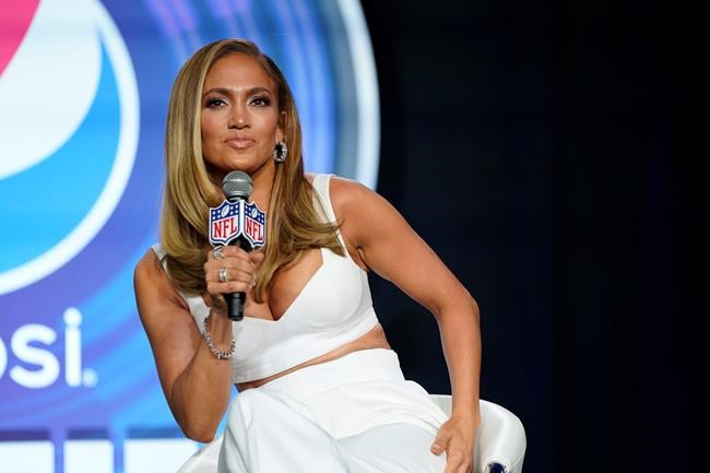 FILE - In this Jan. 30, 2020 file photo, NFL Super Bowl 54 football game halftime performer Jennifer Lopez answers questions at a news conference in Miami. Lopez will give a musical performance on the West Front of the U.S. Capitol when Biden is sworn in as the nation's 46th president next Wednesday. (AP Photo/David J. Phillip)