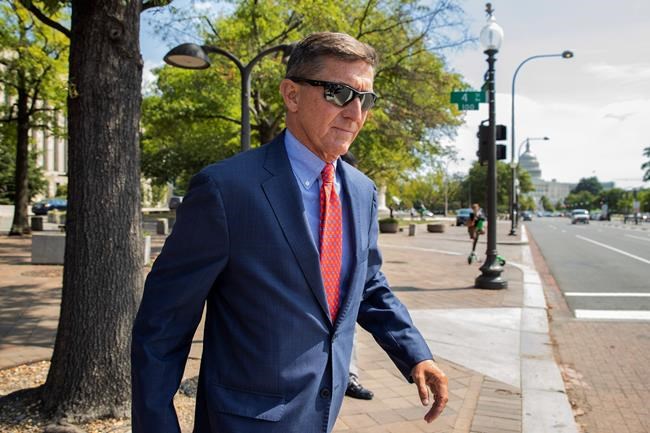 FILE - In this Sept. 10, 2019 file photo, Michael Flynn, President Donald Trump's former national security adviser, leaves the federal court following a status conference in Washington. The arrest of President Donald Trump’s former chief strategist Steve Bannon adds to a growing list of Trump associates ensnared in legal trouble. They include the president's former campaign chair, Paul Manafort, whom Bannon replaced, his longtime lawyer, Michael Cohen, and his former national security adviser, Michael Flynn. (AP Photo/Manuel Balce Ceneta, File)