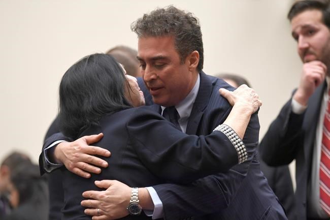 FILE - In this March 7, 2019, file photo, Christine Levinson, wife of Robert Levinson, a former FBI agent who vanished in Iran in 2007, left, gets a hug from Babak Namazi, right, the son of Baquer Namazi who has been held in Iran, following their testimony before a House Foreign Affairs Subcommittee on Capitol Hill in Washington. The killing of a top Iranian general has ratcheted up the anxiety of families of Americans held in Iran. (AP Photo/Susan Walsh, File)