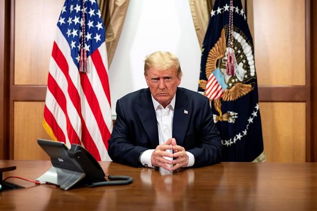 In this image provided by the White House, President Donald Trump listens during a phone call with Vice President Mike Pence, Secretary of State Mike Pompeo, and Chairman of the Joint Chiefs of Staff Gen. Mark Milley, Sunday, Oct. 4, 2020, in his conference room at Walter Reed National Military Medical Center in Bethesda, Md. White House chief of staff Mark Meadows was also in the room, but not pictured, according to the White House. (Tia Dufour/The White House via AP)