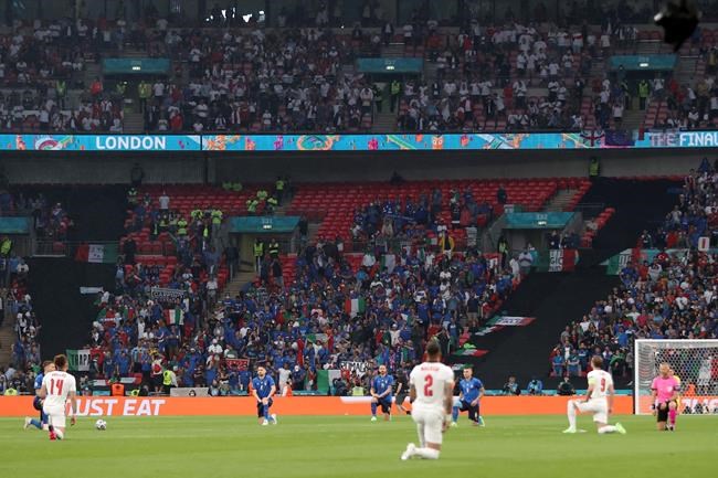 The players take a knee before the Euro 2020 soccer championship final match between England and Italy at Wembley stadium in London, Sunday, July 11, 2021. (Carl Recine/Pool Photo via AP)