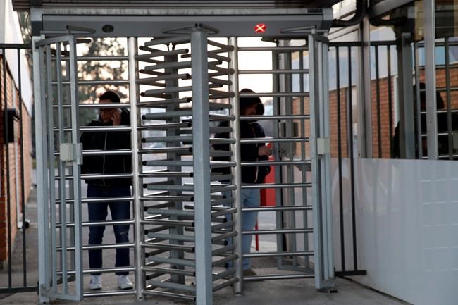 Workers leave the Unilever factory in Casalpusterlengo, near Lodi in Northern Italy, after being tested for virus infection Friday, Feb. 21,2020. Health officials reported the country's first cases of contagion of COVID-19 in people who had not been in China. A man hospitalized in Codogno works here. (AP Photo/Luca Bruno)