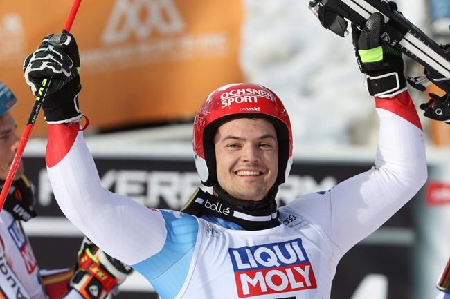 Switzerland's Loic Meillard celebrates his victory in the finish area during an alpine ski, men's World Cup parallel giant slalom, in Chamonix, France, Sunday, Feb. 9, 2020. (AP Photo/Alessandro Trovati)