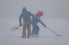 Ski-men work the course as the fog forced to interrupt an alpine ski, men's World Cup downhill, in Saalbach-Hinterglemm, Austria, Friday, March 5, 2021. (AP Photo/Alessandro Trovati)