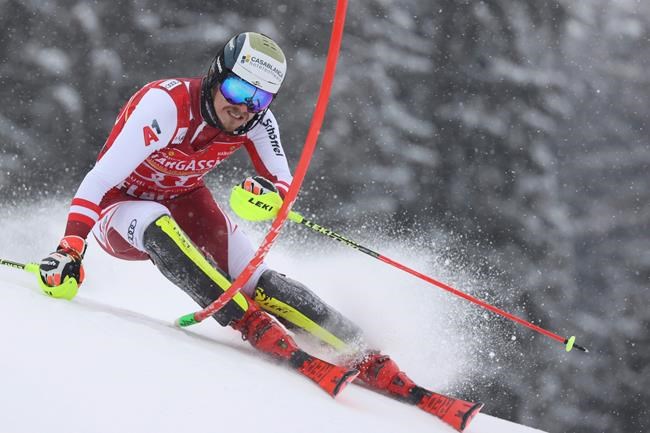 Austria's Manuel Feller speeds down the slope during an alpine ski, men's World Cup slalom in Flachau, Austria, Sunday, Jan. 17, 2021. (AP Photo/Alessandro Trovati)