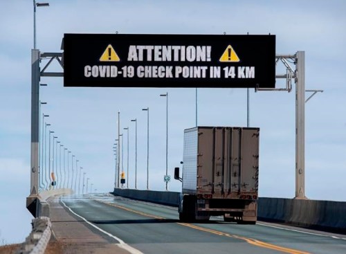 A sign indicates that provincial health department workers will stop traffic that has crossed the Confederation Bridge in Cape Jourimain, N.B. on Sunday, March 22, 2020. Anyone arriving on Prince Edward Island from another province is told to self-isolate for 14 days. This is a step beyond the federal government’s request to those who have travelled internationally. THE CANADIAN PRESS/Andrew Vaughan