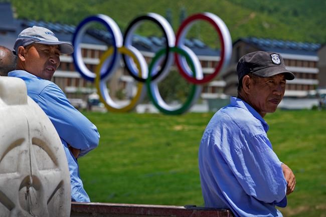 Workers take their break near the Olympics Village for Beijing 2022 Olympic and Paralympic Winter Games and Paralympic Winter Games, during a media tour in Zhangjiakou in northwestern China's Hebei province on Wednesday, July 14, 2021. (AP Photo/Andy Wong)