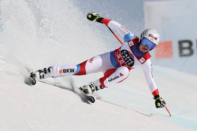 Switzerland's Corinne Suter competes in an alpine ski, women's World Cup downhill, in Crans Montana, Switzerland, Friday, Feb. 21, 2020. (AP Photo/Alessandro Trovati)