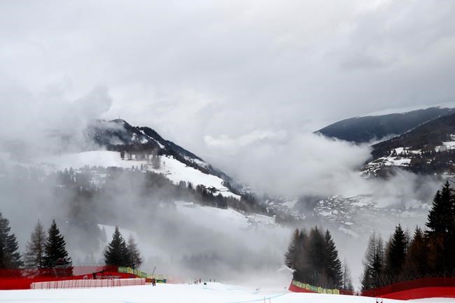 Fog passes over the course of an alpine ski, men's World Cup Super G while the race was interrupted due to the fog, in Val Gardena, Italy, Friday, Dec. 20, 2019. (AP Photo/Gabriele Facciotti)