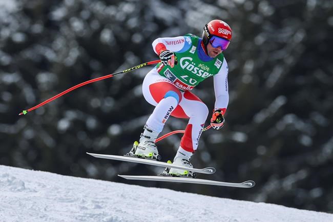 Switzerland's Beat Feuz speeds down the course during an alpine ski, men's World Cup super G, in Saalbach-Hinterglemm, Austria, Sunday, March 7, 2021. (AP Photo/Alessandro Trovati)
