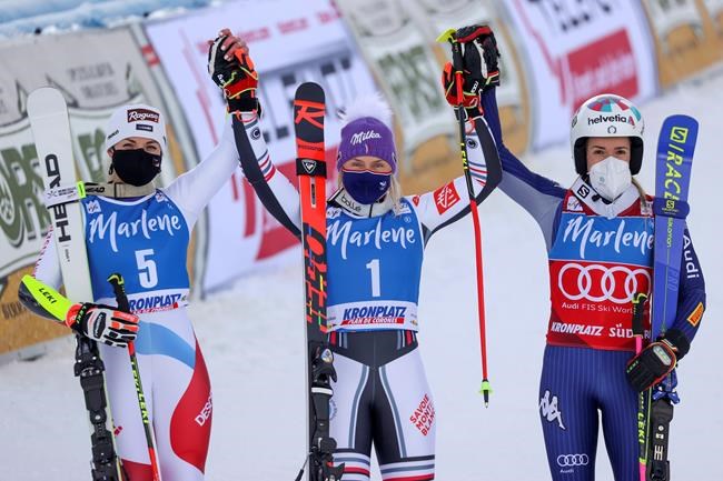 France's Tessa Worley, winner of an alpine ski, women's World Cup giant slalom, celebrates with second-placed Switzerland's Lara Gut-Behrami, left, and third-placed Italy's Marta Bassino, in San Vigilio di Marebbe, Italy, Tuesday, Jan. 26, 2021. (AP Photo/Alessandro Trovati)