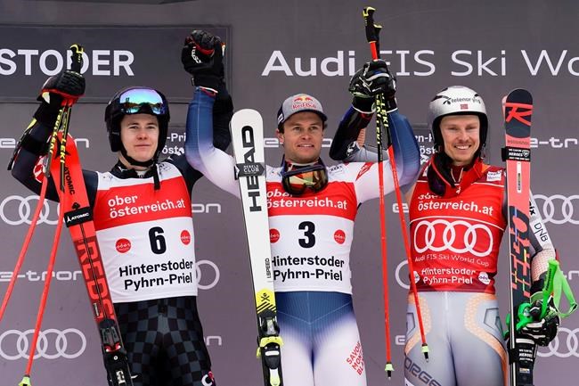 France's Alexis Pinturault, center, winner of an alpine ski, men's World Cup giant slalom, celebrates on the podium with second-placed Croatia's Filip Zubcic, left, and third-placed Norway's Henrik Kristoffersen, in Hinterstoder, Austria, Monday, March 2, 2020. (AP Photo/Giovanni Auletta)