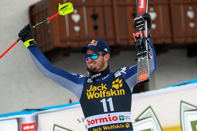 Italy's Dominik Paris celebrates winning an alpine ski, men's World Cup downhill, in Bormio, Italy, Friday, Dec. 27, 2019. (AP Photo/Alessandro Trovati)