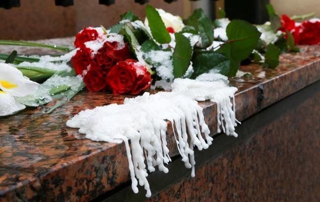 Wax from melted candles next to flowers are placed at the Canadian Embassy during a national day of mourning in Kyiv, Ukraine, Thursday, Jan. 9, 2020, for the victims of the Ukrainian 737-800 plane that crashed on the outskirts of Tehran. A Ukrainian passenger jet carrying 176 people crashed just minutes after taking off from the Iranian capital's main airport, Wednesday, turning farmland on the outskirts of Tehran into fields of debris and killing all on board. (AP Photo/Efrem Lukatsky)