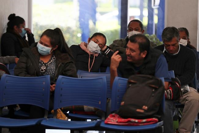 Some people waiting to be admitted to the national hospital that specializes in respiratory diseases, the INER, wear masks over their mouths as a precaution against the spread of the new coronavirus in Mexico City, Friday, Feb. 28, 2020. Mexico’s assistant health secretary announced Friday that the country now has confirmed cases of the COVID-19 virus. (AP Photo/Fernando)