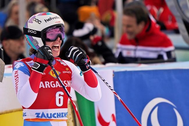 Switzerland's Michelle Gisin reacts as she crosses the finish line of an alpine ski, women's World Cup downhill, in Altenmarkt-Zauchensee, Austria, Saturday, Jan. 11, 2020. (AP Photo/Giovanni Auletta)