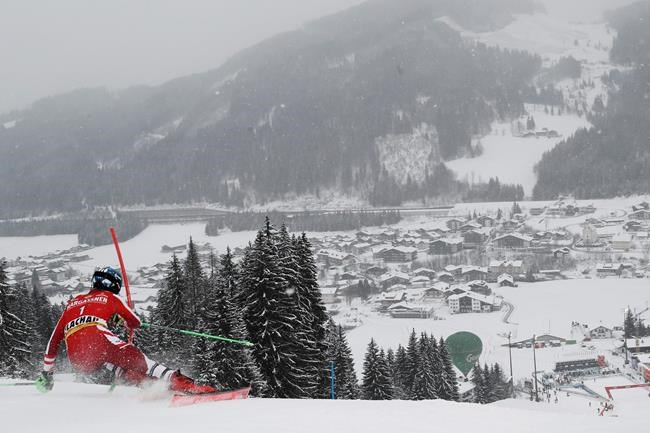 Austria's Marco Schwarz speeds down the slope during an alpine ski, men's World Cup slalom in Flachau, Austria, Sunday, Jan. 17, 2021. (AP Photo/Gabriele Facciotti)