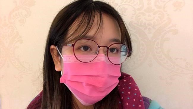 This March 12, 2020 photo provided by Tan Shiyun shows her in her home in Yichang city in central China's Hubei province. Tan, a postgraduate student at a university in Wuhan, had traveled from Wuhan to her family home over 180 miles away in Yichang when she began to experience minor symptoms from the new coronavirus. (Courtesy of Tan Shiyun via AP)