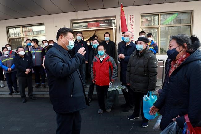 In this photo released by Xinhua News Agency, Chinese President Xi Jinping wearing a protective face mask speaks to residents as he inspects the novel coronavirus pneumonia prevention and control work at a neighbourhoods in Beijing, Monday, Feb. 10, 2020. China reported a rise in new virus cases on Monday, possibly denting optimism that its disease control measures like isolating major cities might be working, while Japan reported dozens of new cases aboard a quarantined cruise ship. (Pang Xinglei/Xinhua via AP)