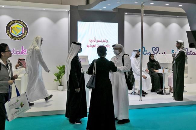 Visitors and exhibitors wear masks at the Arab Health Exhibition in Dubai, United Arab Emirates, Wednesday, Jan. 29, 2020. The United Arab Emirates on Wednesday confirmed the first cases in the Mideast of the new Chinese virus that causes flu-like symptoms, saying doctors now were treating a family that had just come from a city at the epicenter of the outbreak. (AP Photo/Kamran Jebreili)