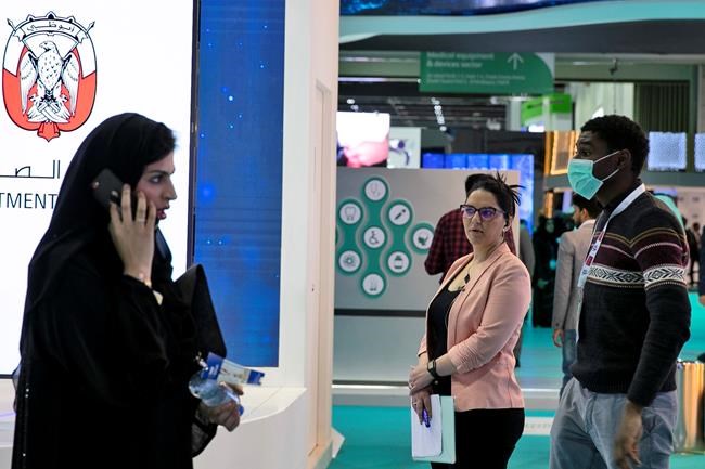 A man wears a mask as he visits the UAE ministry stand during the Arab Health Exhibition in Dubai, United Arab Emirates, Wednesday, Jan. 29, 2020. The United Arab Emirates on Wednesday confirmed the first cases in the Mideast of the new Chinese virus that causes flu-like symptoms, saying doctors now were treating a family that had just come from a city at the epicenter of the outbreak. (AP Photo/Kamran Jebreili)