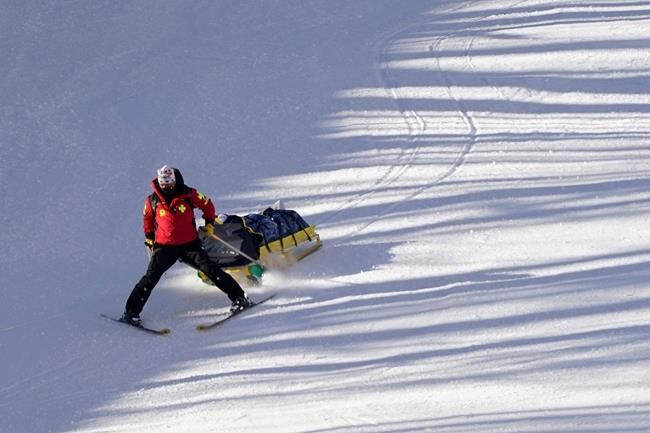 Austria's Nicole Schmidhofer is carried by a toboga after crashing during an alpine ski, women's World Cup Downhill, in Val d'Isere, France, Friday, Dec.18, 2020. (AP Photo/Giovanni Auletta)