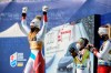 Switzerland's Corinne Suter celebrates on the podium after winning the gold medal in the women's downhill, at the alpine ski World Championships in Cortina d'Ampezzo, Italy, Saturday, Feb. 13, 2021. (AP Photo/Marco Tacca)