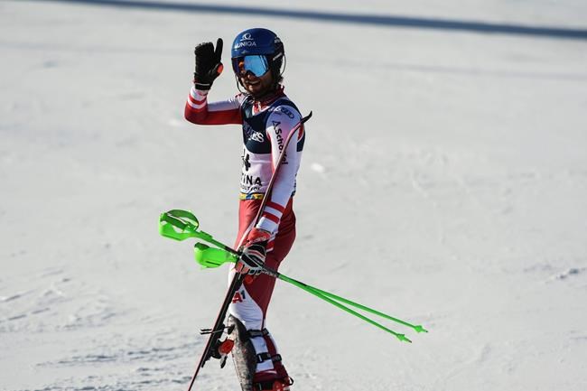 Austria's Marco Schwarz waves after crossing the finish line during the slalom portion of the men's combined race, at the alpine ski World Championships, in Cortina d'Ampezzo, Italy, Monday, Feb. 15, 2021. (AP Photo/Marco Tacca)