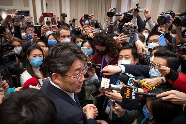 Gao Fu, bottom, the head of the Chinese Center for Disease Control and Prevention (CDC), speaks to journalists after a press conference about a virus outbreak at the State Council Information Office in Beijing, Sunday, Jan. 26, 2020. The new virus accelerated its spread in China, and the U.S. Consulate in the epicenter of the outbreak, the central city of Wuhan, announced Sunday it will evacuate its personnel and some private citizens aboard a charter flight. (AP Photo/Mark Schiefelbein)