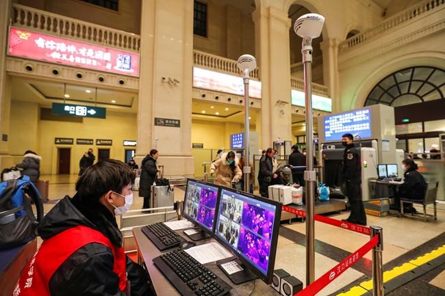 In this Tuesday, Jan. 21, 2020, photo, a worker monitors display screens for infrared thermometers as they check travelers at Hankou Railway Station in Wuhan in southern China's Hubei province. The U.S. on Tuesday reported its first case of a new and potentially deadly virus circulating in China, saying a Washington state resident who returned last week from the outbreak's epicenter was hospitalized near Seattle. (Chinatopix via AP)
