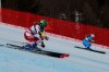 Austria's Katharina Liensberger and Italy's Marta Bassino speed down the course on their way to win a gold medal during a parallel slalom, at the alpine ski World Championships, in Cortina d'Ampezzo, Italy, Tuesday, Feb. 16, 2021. (AP Photo/Marco Trovati)