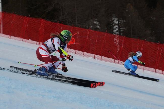 Austria's Katharina Liensberger and Italy's Marta Bassino speed down the course on their way to win a gold medal during a parallel slalom, at the alpine ski World Championships, in Cortina d'Ampezzo, Italy, Tuesday, Feb. 16, 2021. (AP Photo/Marco Trovati)