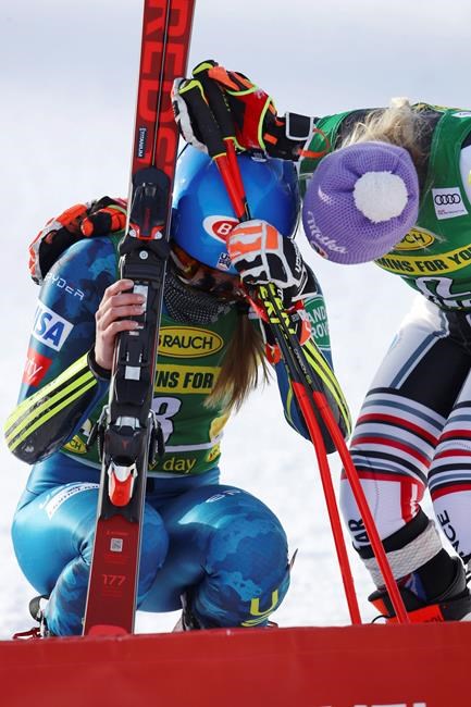 United States' Mikaela Shiffrin is embraced by France's Tessa Worley, right, at finish area after completing an alpine ski women's World Cup giant slalom in Courchevel, France, Monday, Dec. 14, 2020. (AP Photo/Marco Trovati)