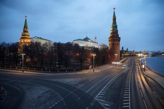 A view of the unusually empty embankment during evening rush hour outside the Kremlin in Moscow, Russia, Wednesday, April 1, 2020. The Russian capital has woken up to a lockdown obliging most people in the city of 13 million to stay home. The government ordered other regions of the vast country to quickly prepare for the same as Moscow, to stem the spread of the new coronavirus. The new coronavirus causes mild or moderate symptoms for most people, but for some, especially older adults and people with existing health problems, it can cause more severe illness or death. (AP Photo/Pavel Golovkin)