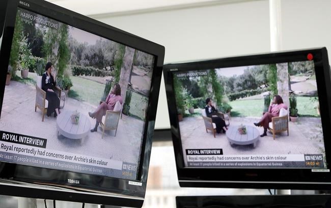 Australian television news in Sydney, Monday, March 8, 2021, reports on an interview of The Duke and Duchess of Sussex by Oprah Winfrey. The interview airs in Australia Monday evening. (AP Photo/Rick Rycroft)