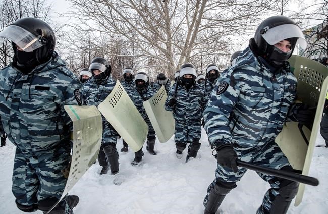 Riot police officers run during a protest against the jailing of opposition leader Alexei Navalny in Yekaterinburg, Russia, Saturday, Jan. 23, 2021. Russian police on Saturday arrested hundreds of protesters who took to the streets in temperatures as low as minus-50 C (minus-58 F) to demand the release of Alexei Navalny, the country's top opposition figure. A Navalny, President Vladimir Putin's most prominent foe, was arrested on Jan. 17 when he returned to Moscow from Germany, where he had spent five months recovering from a severe nerve-agent poisoning that he blames on the Kremlin. (AP Photo/Anton Basanayev)