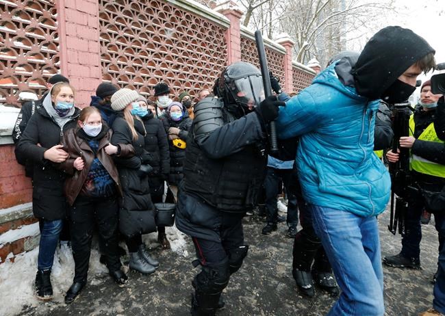 Police officers detain a man during a protest near the Matrosskaya Tishina prison where Alexei Navalny is being held, in Moscow, Russia, on Sunday, Jan. 31, 2021. Chanting slogans against President Vladimir Putin, thousands of people took to the streets Sunday across Russia's vast expanse to demand the release of jailed opposition leader Alexei Navalny, keeping up the nationwide protests that have rattled the Kremlin. Over 1,600 were detained by police, according to a monitoring group. (AP Photo/Alexander Zemlianichenko)
