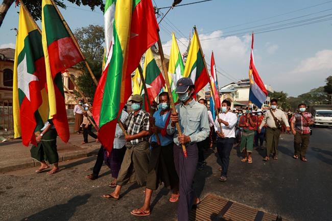 Supporters of the Myanmar military and the military-backed Union Solidarity and Development Party march while holding Myanmar flags as they continue to protest election results during a rally near Shwedagon pagoda Saturday, Jan. 30, 2021, in Yangon, Myanmar. Myanmar’s military has denied that controversial statements by its chief were meant as a threat to stage a coup, claiming the media had misinterpreted his words. Political tension soared this past week after the military said it could not rule out a coup if its complaints of widespread voting fraud in last November’s election were ignored. (AP Photo/Thein Zaw)
