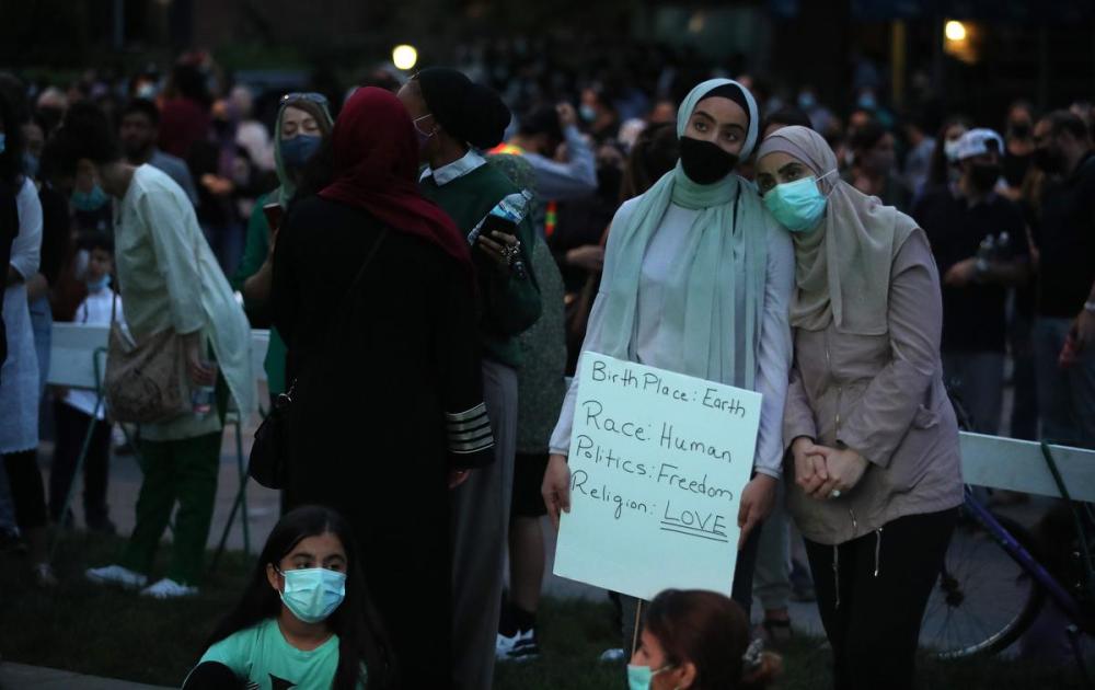 Steve Russell - Toronto Star
People gather Tuesday evening to grieve the Muslim family killed when a 20 year old man allegedly targeted them with his truck and ran them down at a crosswalk in London, Ont.
