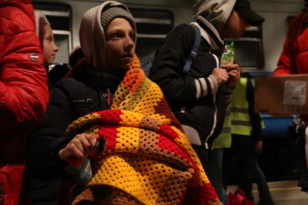 Johanna Chisholm
Children fleeing war in Ukraine receive snacks, drinks from Polish volunteers at the train station in Przemysl, Poland on Monday.