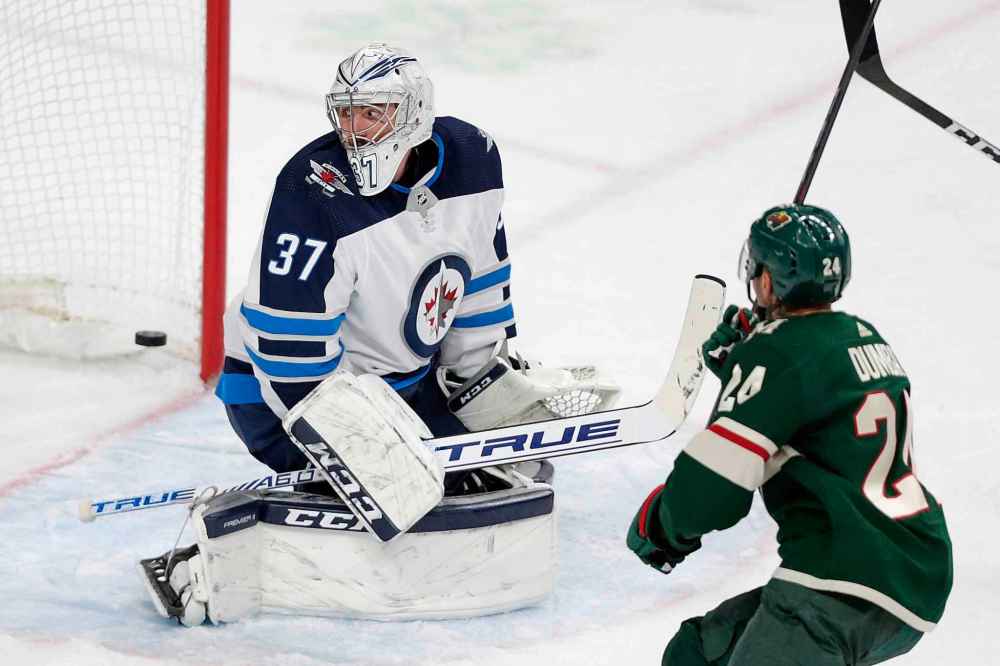 CP
Winnipeg Jets goalie Connor Hellecuyck (37) watches a goal by the Minnesota Wild in the third period as Minnesota Wild defenseman Matt Dumba (24) skates by in the third period. (Andy Clayton-King/The Associated Press)