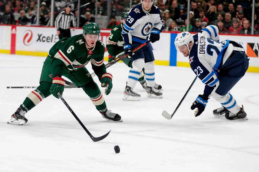 CP
Minnesota Wild Ryan Donato (6) and Winnipeg Jets defenseman Carl Dahlstrom vie for the puck in the first period. (Andy Clayton-King/The Associated Press)