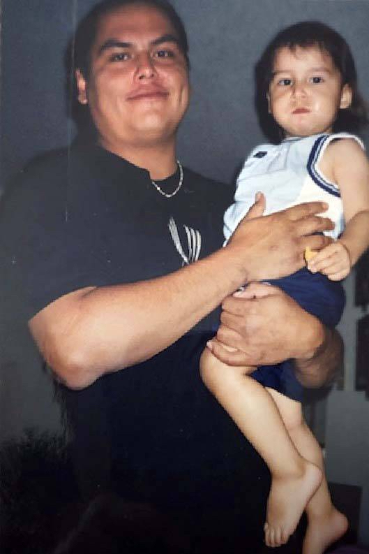 Will Ahmo, pictured holding son Emory, died while an inmate at Headingley Correctional Institution. (Supplied)