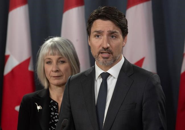 Minister of Health Patty Hajdu looks on as Prime Minister Justin Trudeau speaks during a news conference on the coronavirus situation, in Ottawa, Wednesday March 11, 2020. THE CANADIAN PRESS/Adrian Wyld