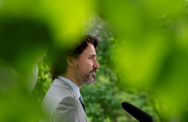 Prime Minister Justin Trudeau listens to a question from a reporter during a news conference outside Rideau cottage in Ottawa, Thursday June 4, 2020. THE CANADIAN PRESS/Adrian Wyld