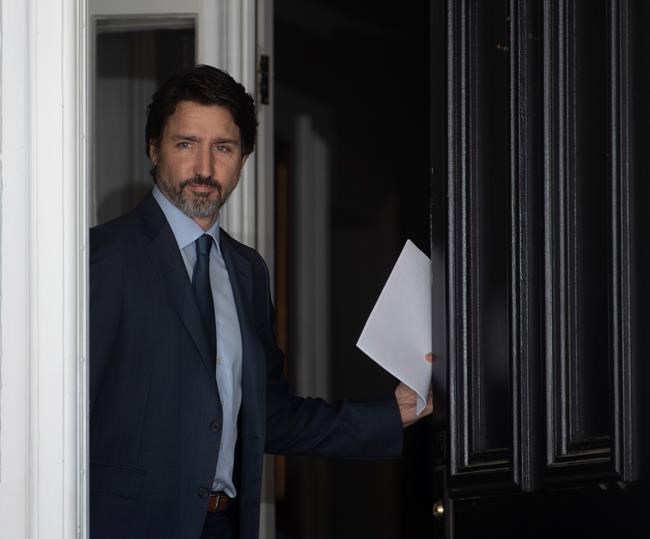 Prime Minister Justin Trudeau walks out the front door of Rideau Cottage as he makes his way to speak at a news conference at Rideau Cottage in Ottawa, Wednesday June 17, 2020. THE CANADIAN PRESS/Adrian Wyld